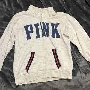A PINK quarter zip sweatshirt.